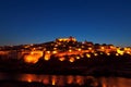 Walled town illuminated at night