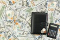 Wallet, coins, calculator on the background of dollar bills Royalty Free Stock Photo