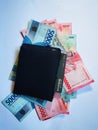 A wallet complete with money and credit cards, pictured in Padang City, Indonesia. in the photo on December 9, 2023