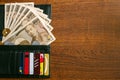 a wallet containing Japanese money and credit cards lying on a wooden table Royalty Free Stock Photo