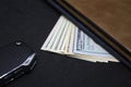 Wallet with dollars on a dark background