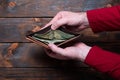 Wallet with dollars in men`s hands. Wallet with money on a wooden background Royalty Free Stock Photo