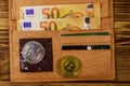 Wallet with fifty euro bills and bitcoins on wooden background Royalty Free Stock Photo