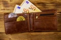 Wallet with fifty euro bills and bitcoins on wooden background Royalty Free Stock Photo