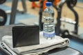 wallet on gym bench with water bottle and towel Royalty Free Stock Photo