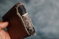 a wallet made of brown synthetic leather that had been torn at the back Royalty Free Stock Photo