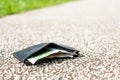 Wallet with money drop on the street and lost