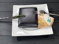 Wallet with money on a plate.
