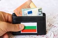 Wallet with protruding euro banknotes and the symbol of Bulgaria, The concept of currency change and Bulgarias willingness to Royalty Free Stock Photo