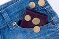 Wallet and small money are lying in side pocket of blue jeans Royalty Free Stock Photo