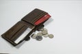 A wallet and UAE dirhams and coins with white background