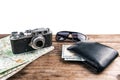 Wallet, vintage camera, map and money on wooden background Royalty Free Stock Photo