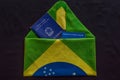 wallet of work within the letter formed by the flag of the brazil with the inscripition, ministry of labour and employment