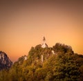 Wallfahrtskirche St. Pankraz church building on a cliff against the beautiful sunset sky, Germany