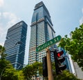 Wallich Street sign and traffic light red light over skycraper and summer blue sky