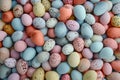 A wallpaper all with dense collection of speckled Easter eggs in a spectrum of pastel hues, a vibrant and textured