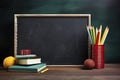 wallpaper, blackboard background, with desk, above desk colored pencils and some healthy red apples, back to school Royalty Free Stock Photo