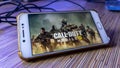 The wallpaper of Call of Duty Mobile version game on a smartphone Royalty Free Stock Photo