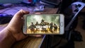 The wallpaper of Call of Duty Mobile version game on a smartphone Royalty Free Stock Photo