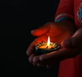 A girl holding diya in her hand to celebrate diwali and dhanteras Royalty Free Stock Photo