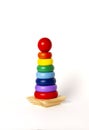 Toy pyramid, wooden, multi - colored rings, on a white background