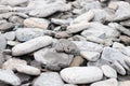 Wallpaper of various gray and orange rocks of different sizes and shapes on the sea coast