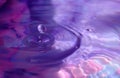 Wallpapers. Frozen movement of water. Drops of water falling and splashing. Violet/pink color.