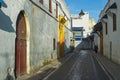 The walls of the ancient city and a woman, dressed in the Arab national clothes, walking through the old streets of the town of Sa