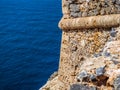 Walls of ancient fortress tower over the blue sea Royalty Free Stock Photo