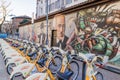 Walls artistics graffitis and bicycles station in Milan, Italy