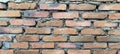 the walls of the house with piles of unfinished red bricks