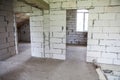 Walls from lightweight aggregate concrete block with empty doorframes, unfinished interior, house under construction Royalty Free Stock Photo