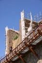 The walls of the Monteriggioni fortress under repair.