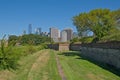 Walls off Fort Jay, Governor`s island, with skyscrapers of Manhattan behind.USA Royalty Free Stock Photo