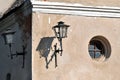 Walls of an old house with a round window and a lanterns in the Royalty Free Stock Photo