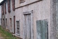 Walls of old houses with closed wooden shutters windows and boarded up doors Royalty Free Stock Photo