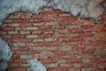 Walls of old red brick. The wall texture. With pieces smeared putty. Showered Royalty Free Stock Photo