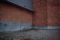 Walls of red brick building and grey brick floor