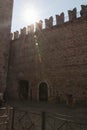 Walls at the Scaliger Castle with sun on background, Sirmione, Lombardy, Italy