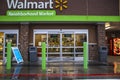 Walmart neighborhood grocery store in the rain entrance and covid-19 sign