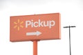 tor, canada - august 18, 2023: walmart pickup logo sign orange white yellow with arrow on orange metal post 34 p 20