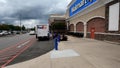 Walmart store exterior sidewalk and fancy stone wall Fed Ex truck