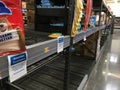 Walmart Supercenter interior out of stock signs on toilet paper and empty sections
