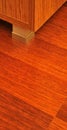 Walnut cabinet and corner detail on mahogany parquet in luxury house