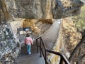 Visitors exploring the pre Colombian cave dwellings in the limestone cliffs of Walnut Canyon