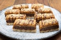 Walnut chocolate cake on a plate. Delicious caramel chocolate tart, topped with nuts and hazelnuts, almonds Royalty Free Stock Photo