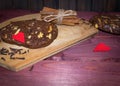 Walnut chocolate cookies with cinnamon sticks on wooden planks background