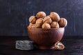 Walnut in a clay bowl, young and broken walnut