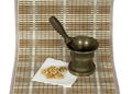 Walnut and the copper pounder (mortar) on the matting Royalty Free Stock Photo