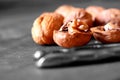 Walnut cracked open with nutcracker on wooden background. Royalty Free Stock Photo